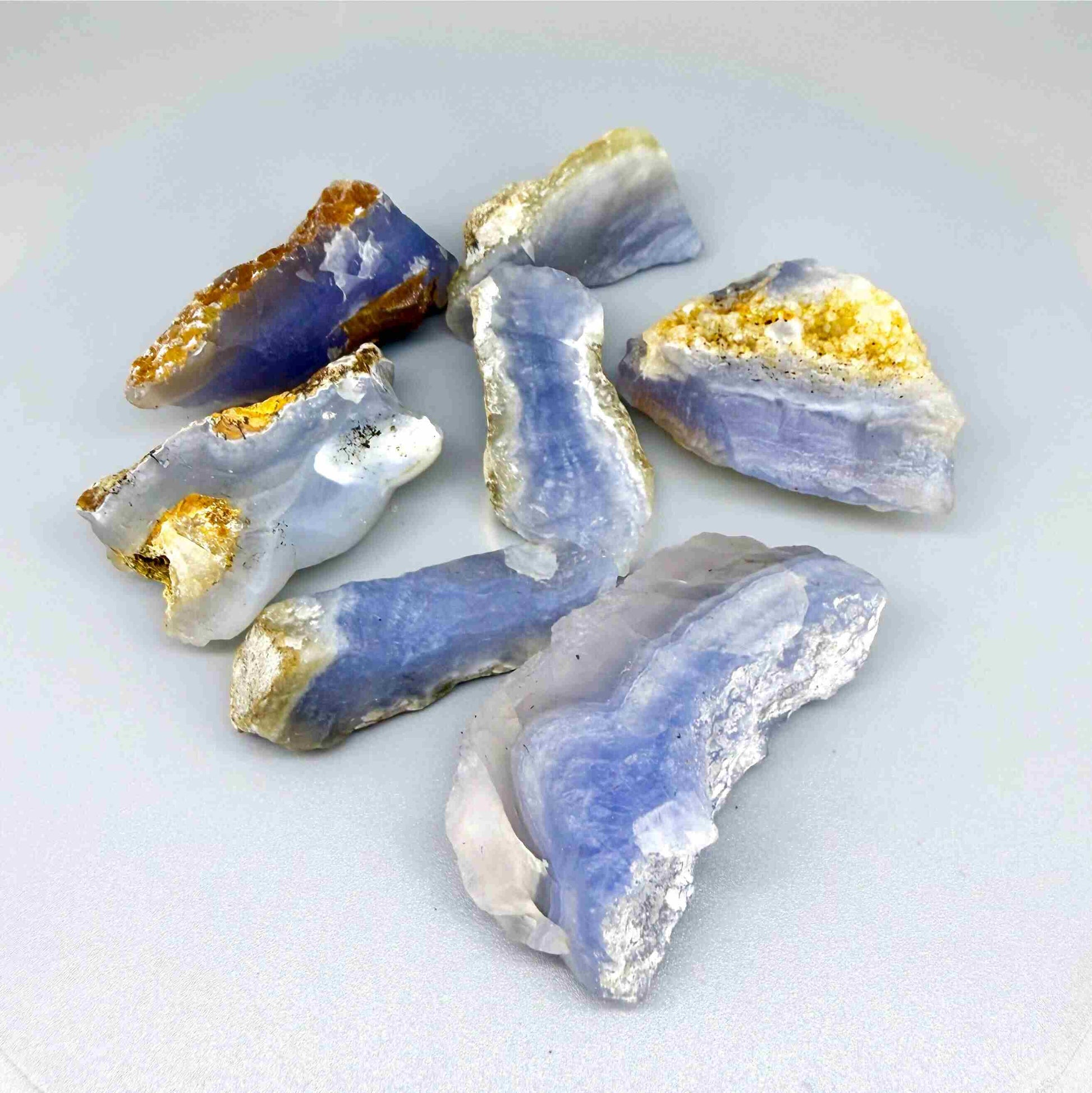 Untreated blue chalcedony rough lot with milky texture and natural blue banding