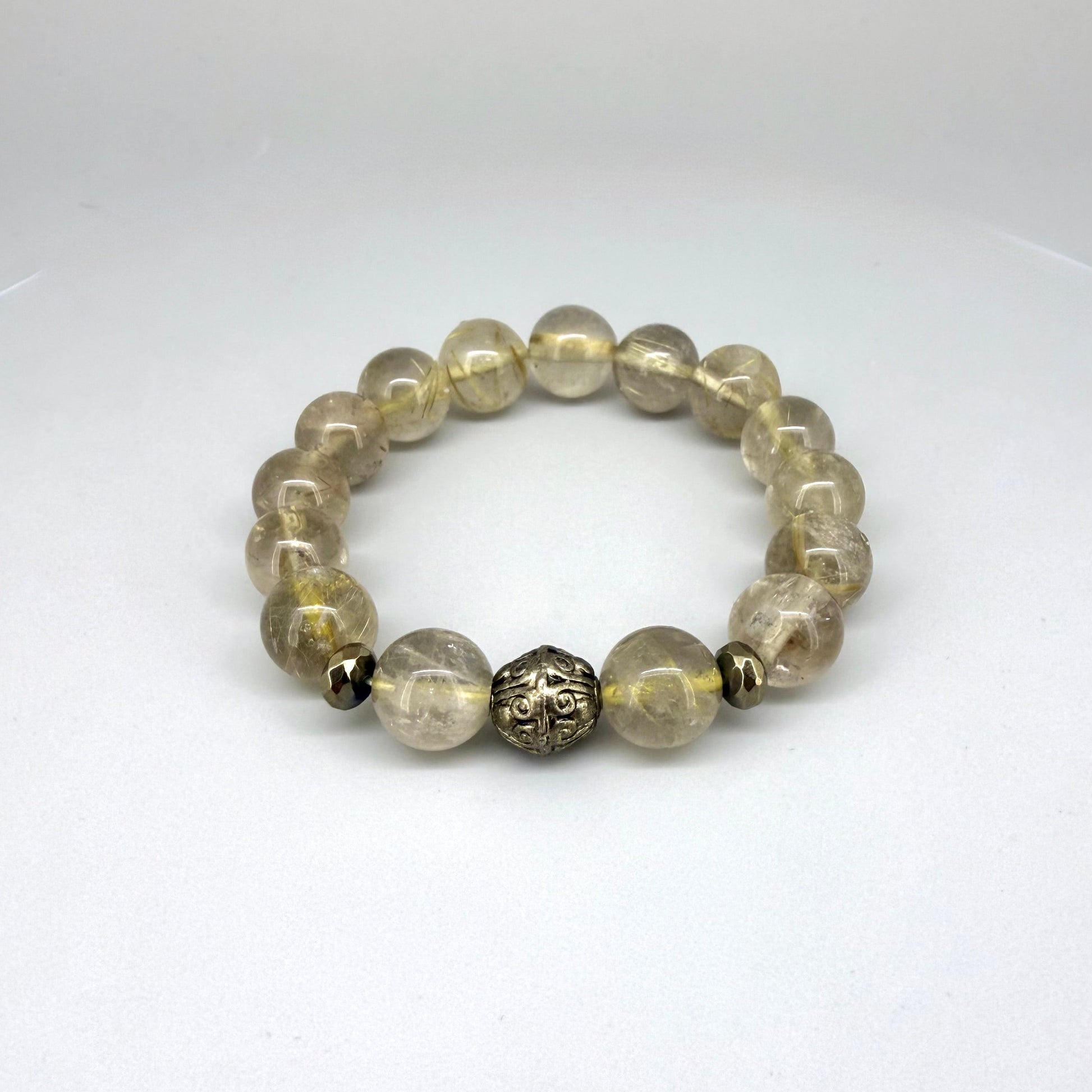 Rutilated quartz beaded bracelet, natural golden rutile gemstone beads with one carved metal accent bead on elastic stretch band.