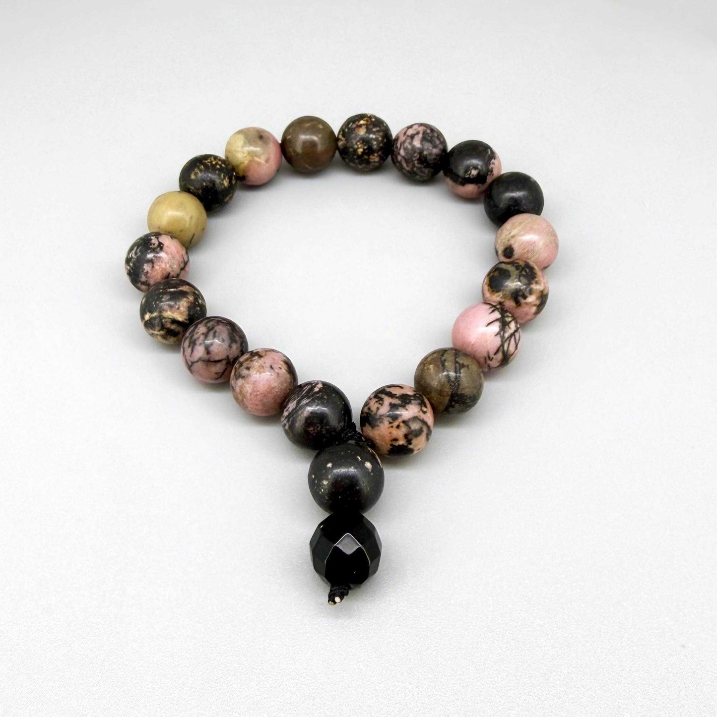 Rhodonite mala bracelet made from natural rhodonite beads, symbolizing emotional healing, compassion, and balance.
