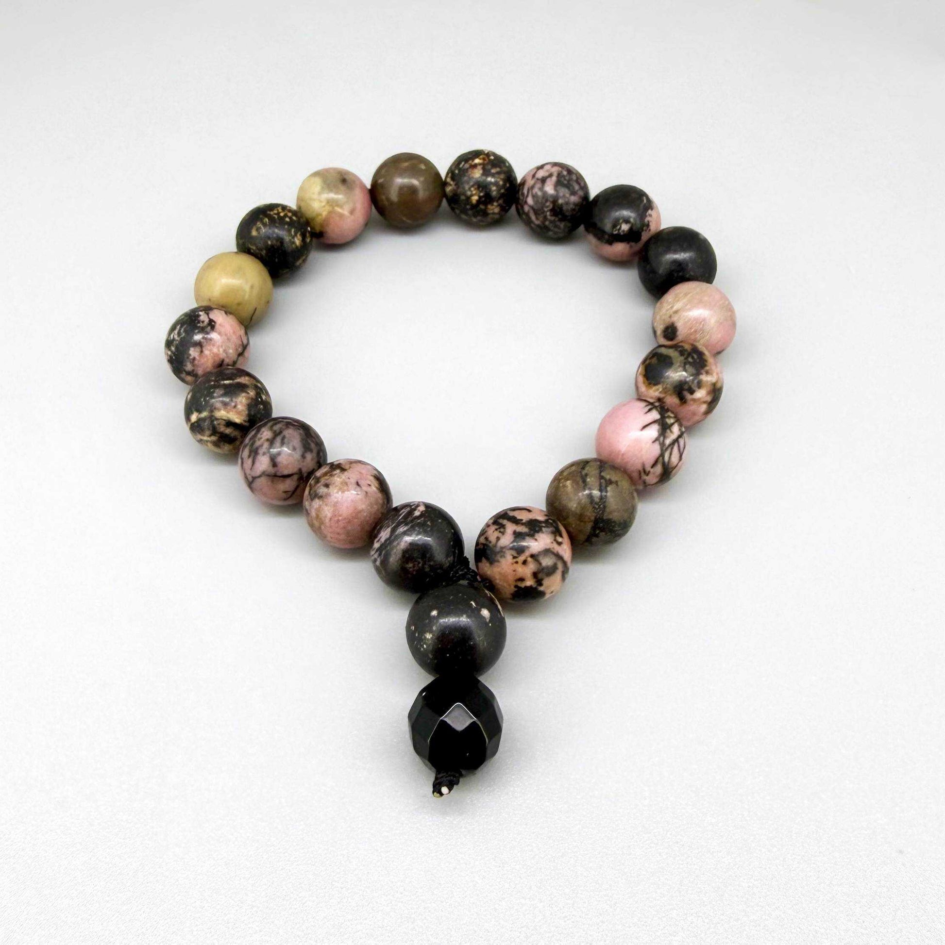 Rhodonite mala bracelet made from natural rhodonite beads, symbolizing emotional healing, compassion, and balance.