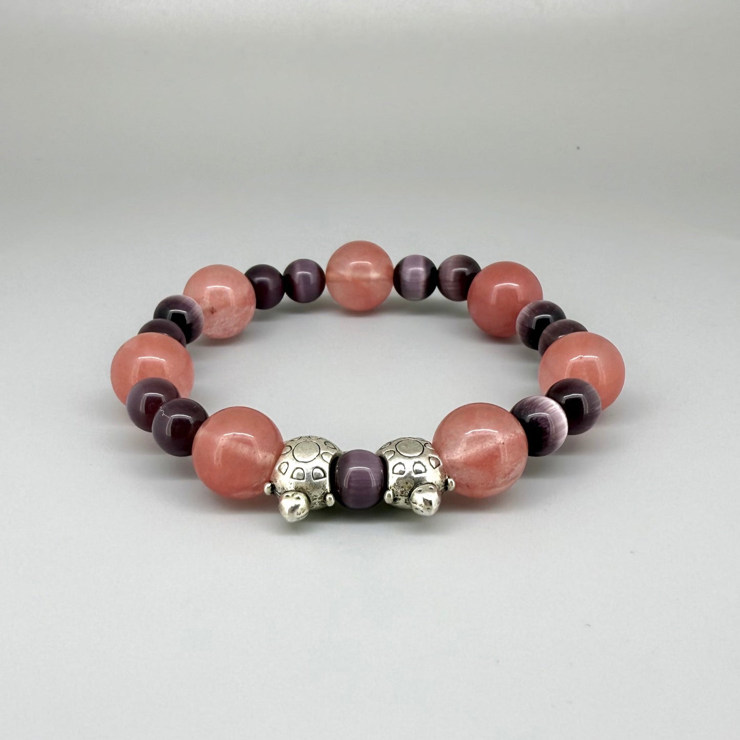 Cherry quartz and cat’s eye beaded bracelet, 18cm, pink and shimmering gemstone beads with two turtle accents on elastic stretch band.