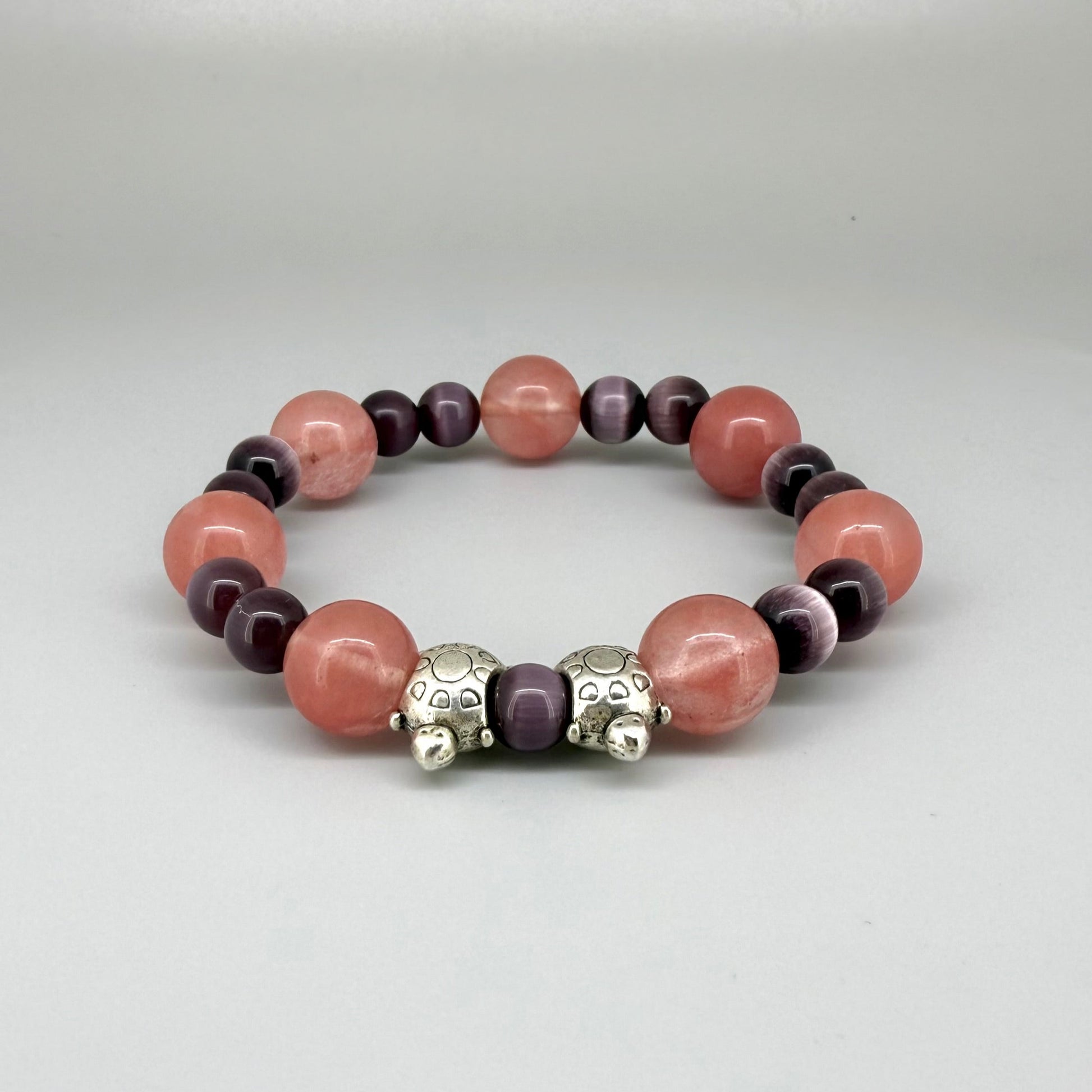 Cherry quartz and cat’s eye beaded bracelet, 18cm, pink and shimmering gemstone beads with two turtle accents on elastic stretch band.