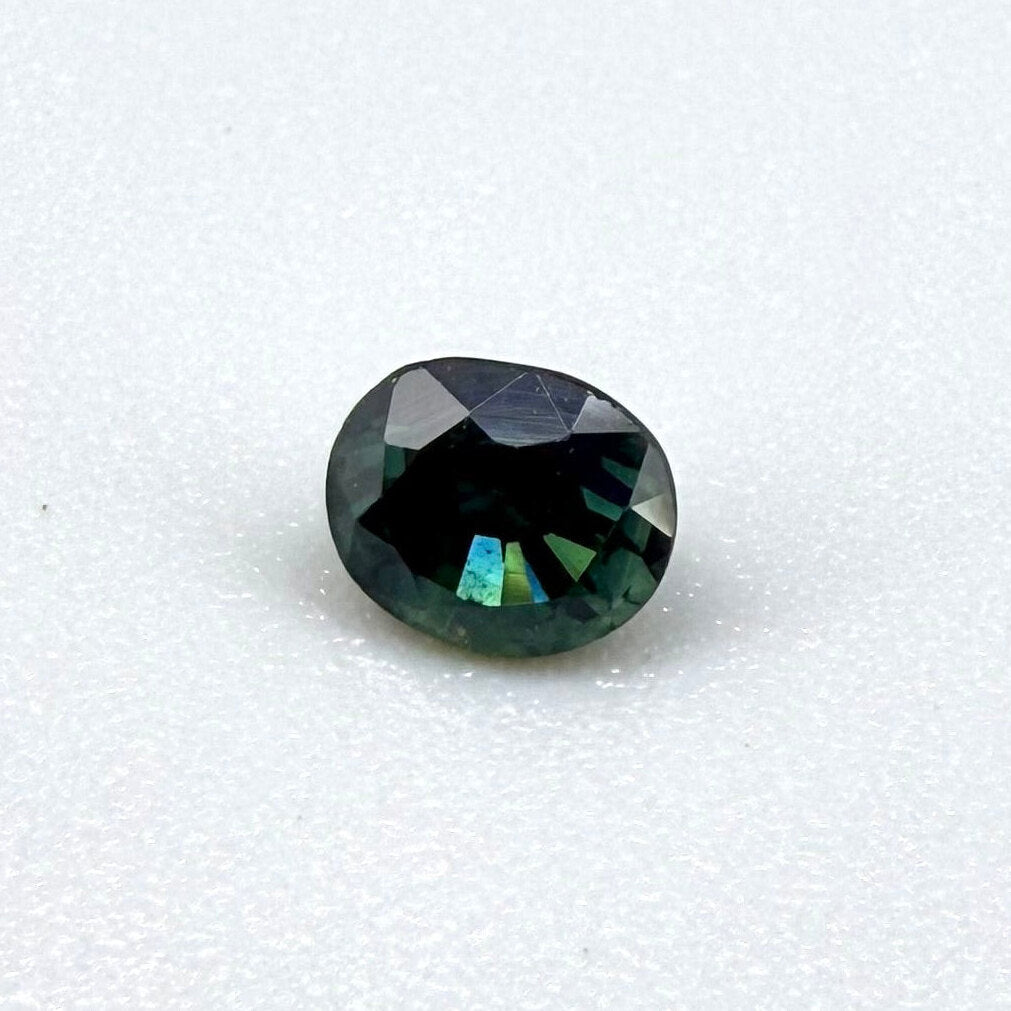 0.67 ct natural blue-green sapphire from Bangkaja, faceted cut.