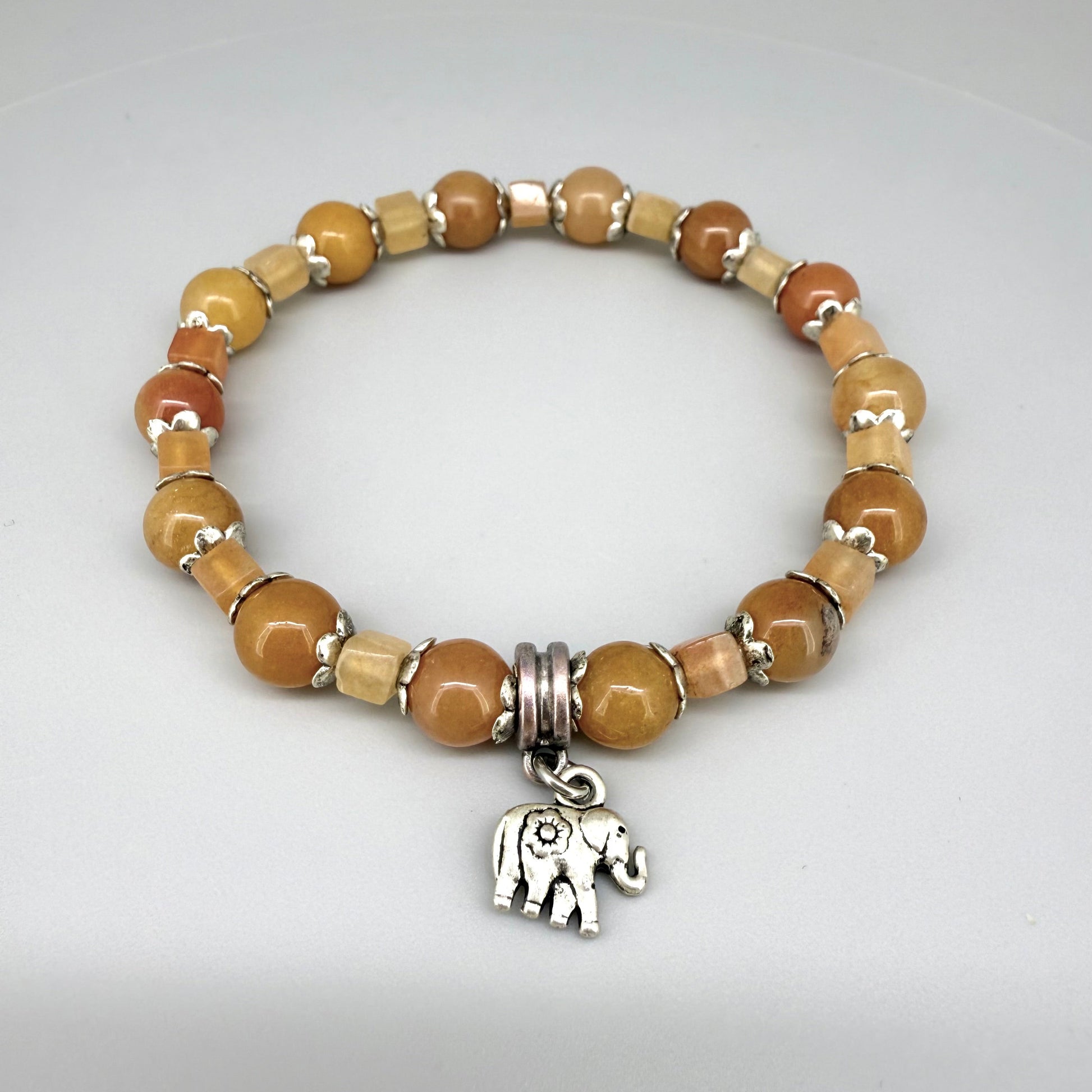 Jade and aventurine beaded bracelet, 18cm, yellow and light brown gemstone beads in round and square shapes with elephant charm on elastic stretch band.