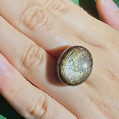 Golden-brown star sapphire cabochon, natural gemstone with subtle asterism