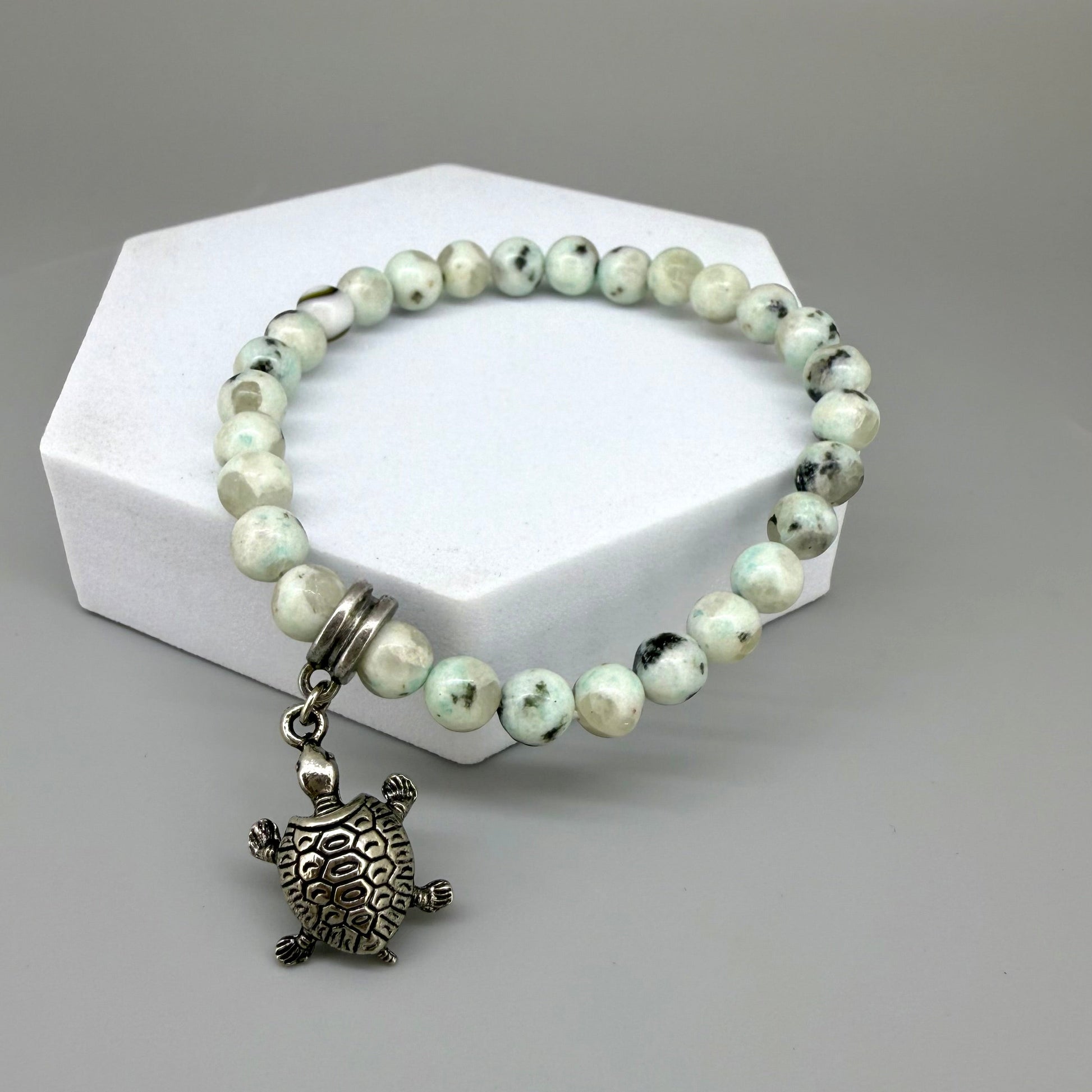 Dalmatian jasper beaded bracelet, 18cm, earthy gemstone beads with metal turtle charm on elastic stretch band.