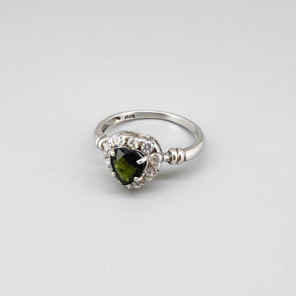 White gold plated silver solitaire ring with heart-shaped green sapphire and cubic zirconia centerpiece.