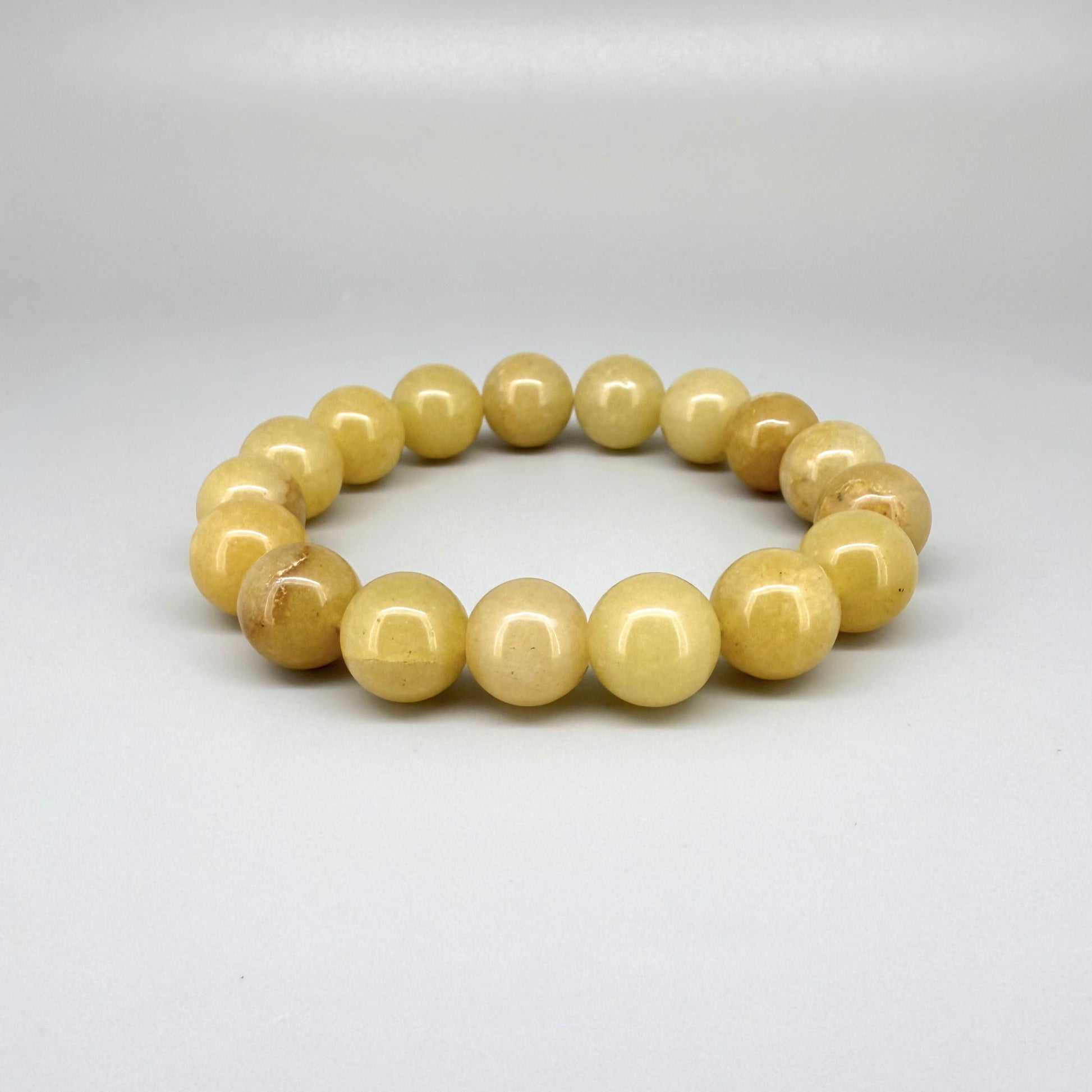Jade beaded bracelet, 19cm, natural yellow-cream gemstone beads on elastic stretch band.