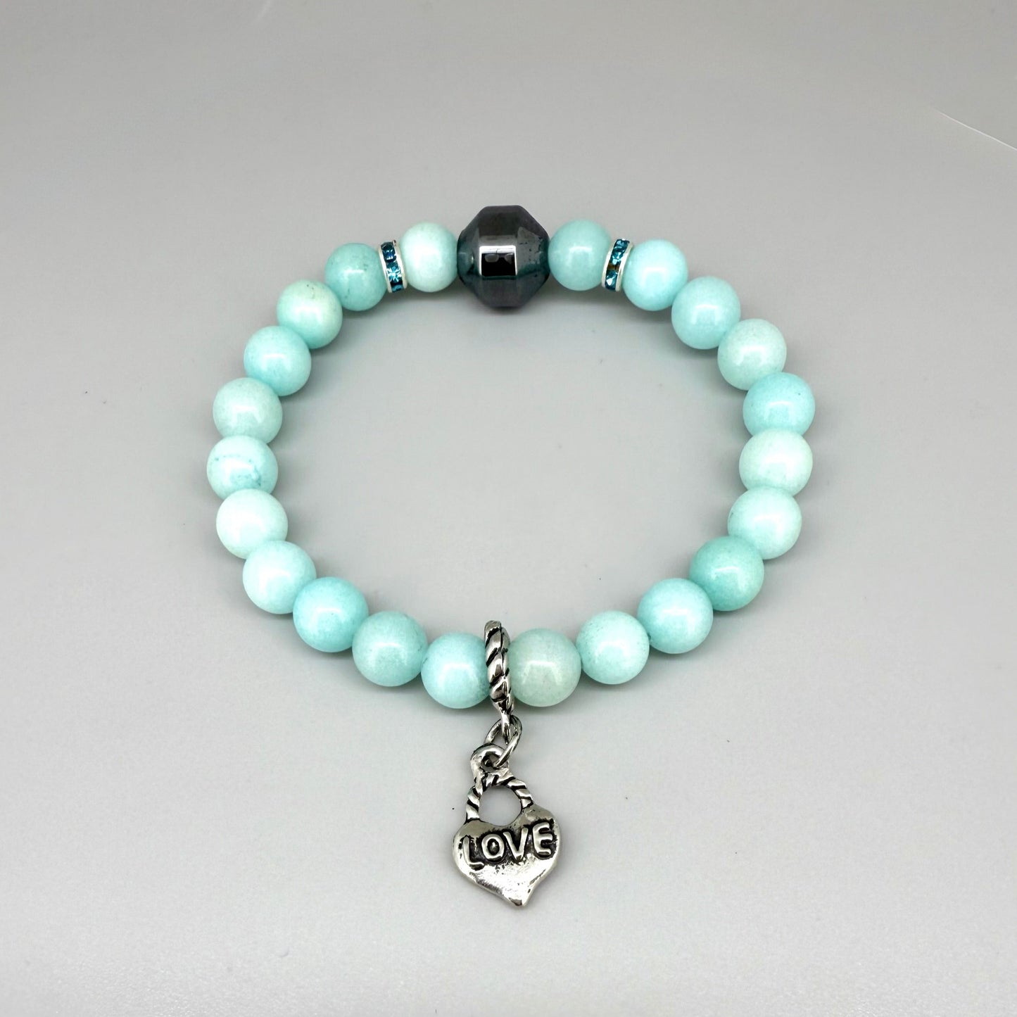 Agate beaded bracelet, 19cm, aqua-blue gemstone beads with decorative medallion accent on elastic stretch band.