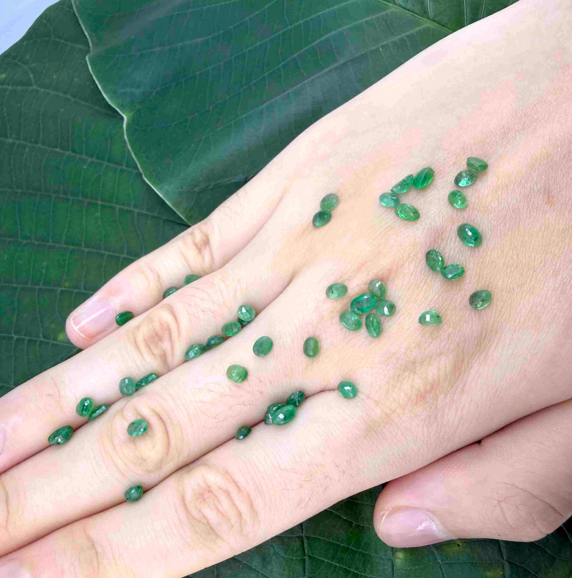 8.9 ct natural untreated Zambian emerald lot, faceted oval stones with vivid bluish-green color.