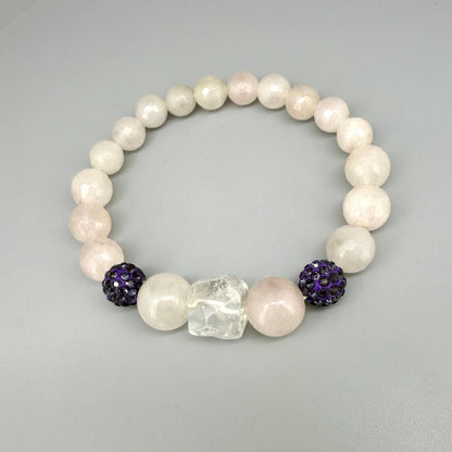 Rose quartz beaded bracelet, 19cm, light pink gemstone beads with larger central rose quartz bead and black sparkling accent beads on elastic stretch band.