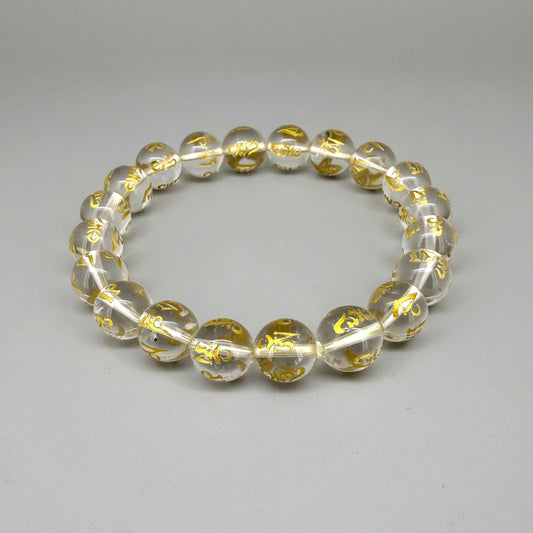 Clear quartz beaded bracelet, 19cm, transparent gemstone beads engraved with golden Sanskrit mantra Om Mani Padme Hum on elastic stretch band.