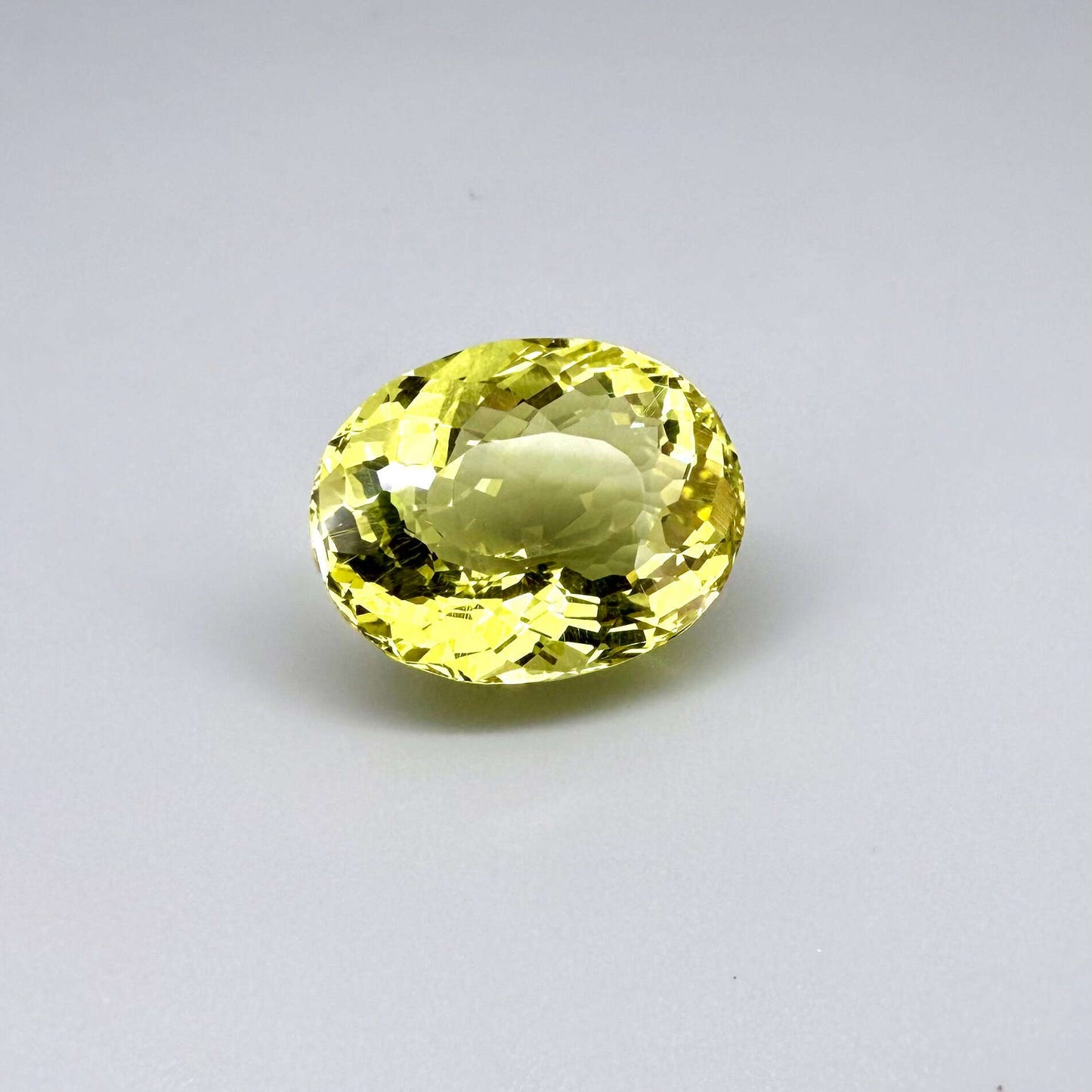 28.09 ct natural lemon quartz from Africa, oval cut with bright yellow color.