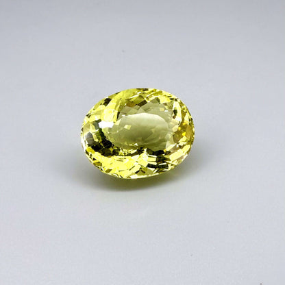 28.09 ct natural lemon quartz from Africa, oval cut with bright yellow color.