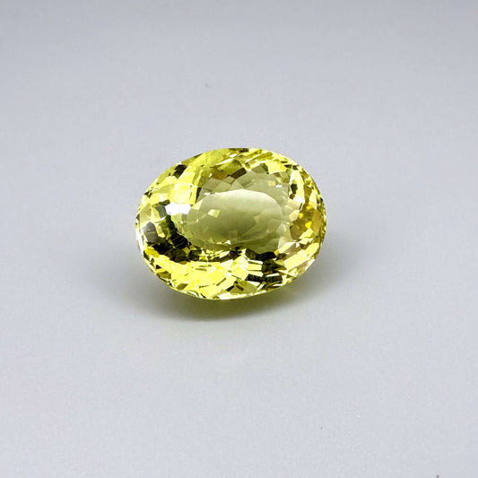 28.09 ct natural lemon quartz from Africa, oval cut with bright yellow color.