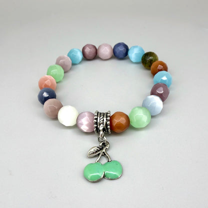 Pastel cat’s eye beaded bracelet, 19cm, multicolor shimmering beads with green cherry charm on elastic stretch band.