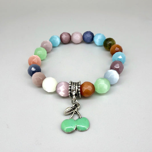Pastel cat’s eye beaded bracelet, 19cm, multicolor shimmering beads with green cherry charm on elastic stretch band.