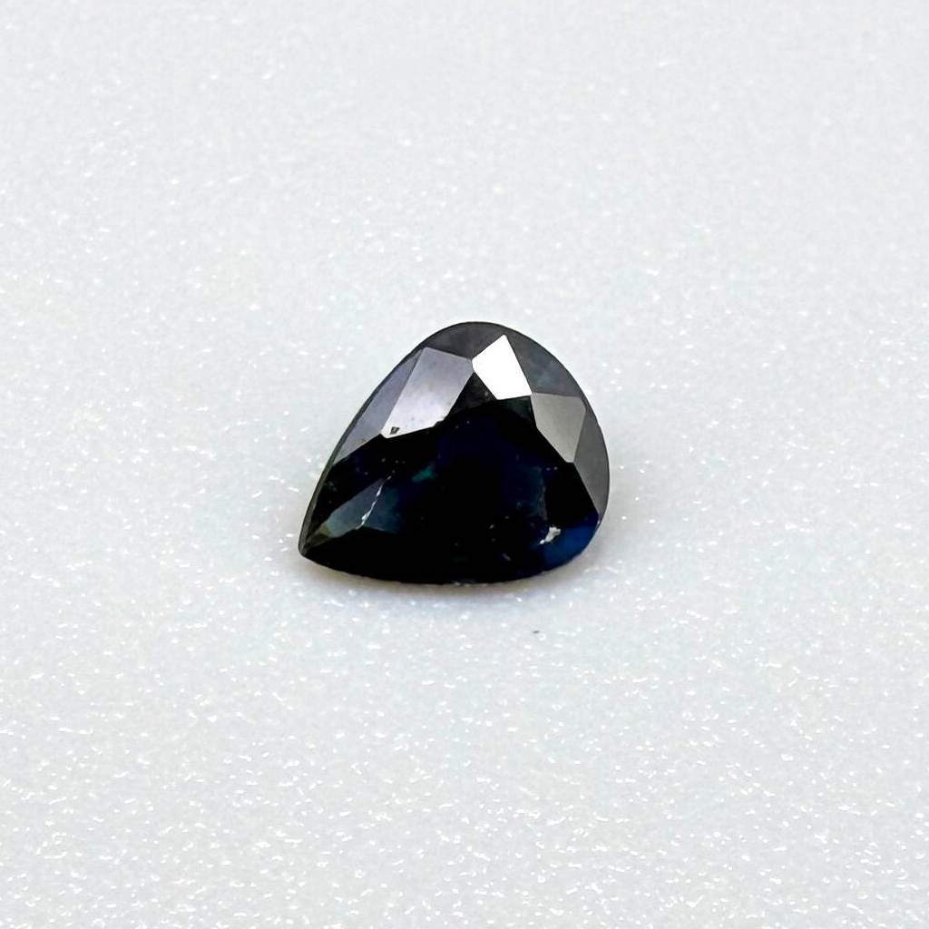 0.35 ct natural dark-blue sapphire from Bangkaja, pear cut.
