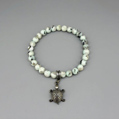 Dalmatian jasper beaded bracelet, 18cm, earthy gemstone beads with metal turtle charm on elastic stretch band.