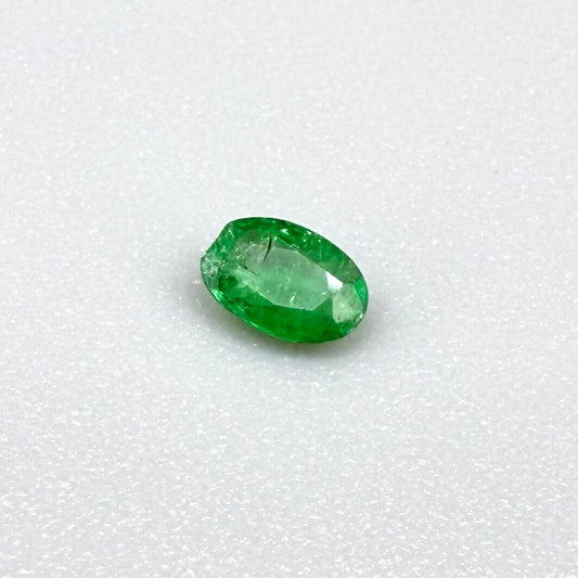 0.16 ct natural untreated Zambian emerald, oval faceted with bright bluish-green color.