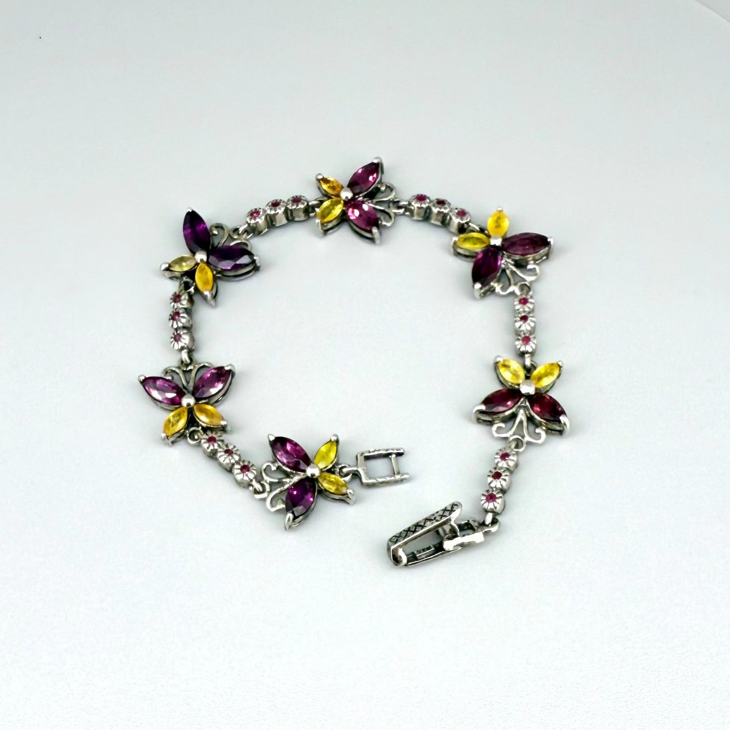 Gem Butterfly bracelet with rhodolite, sapphire and ruby gemstones set in white gold plated silver