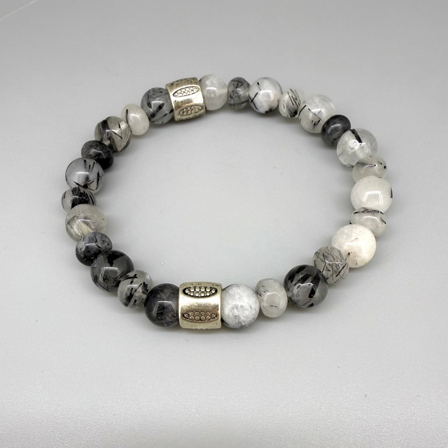 Rutilated quartz beaded bracelet, 18cm, black-white-grey gemstone beads with two decorated metal spacers on elastic band.