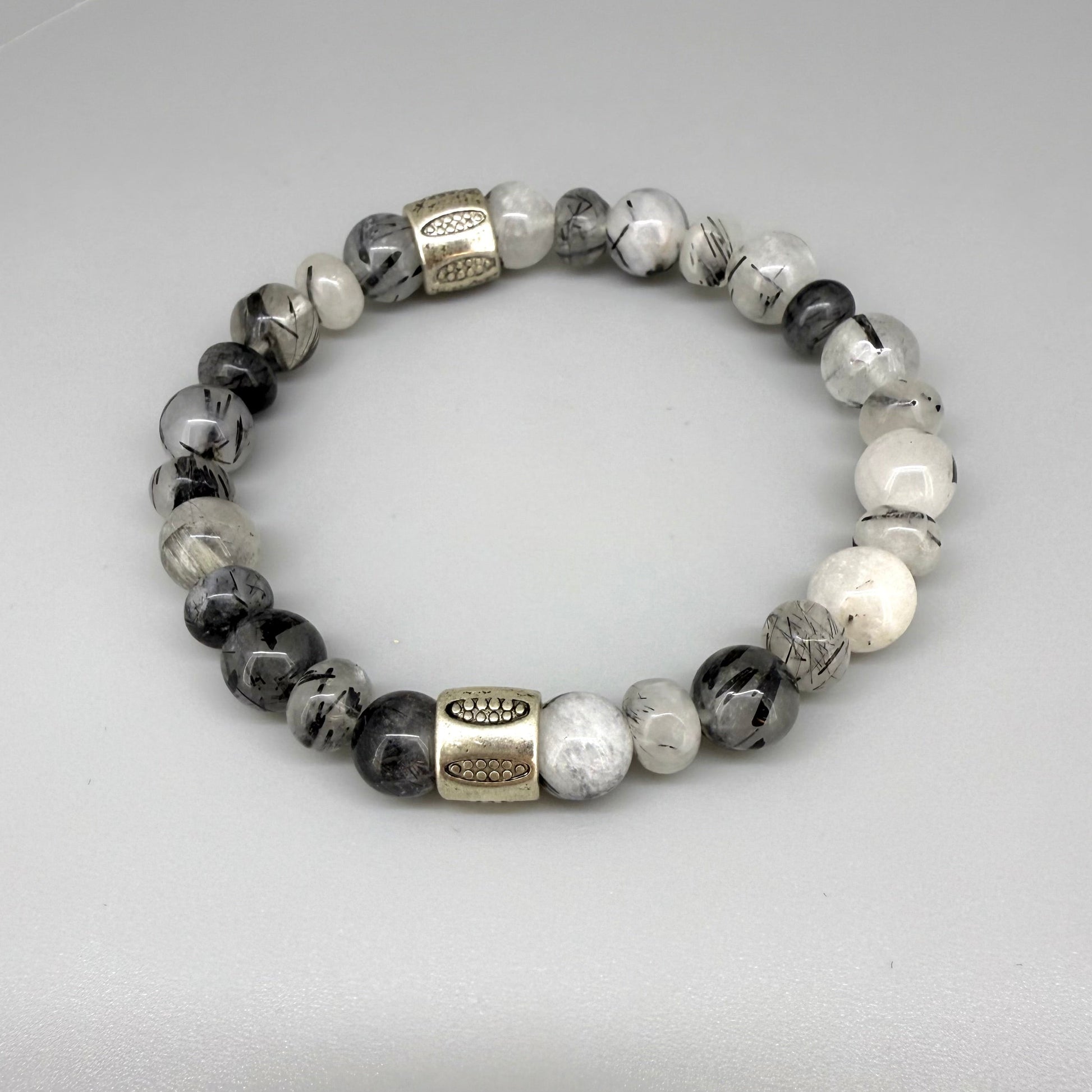 Rutilated quartz beaded bracelet, 18cm, black-white-grey gemstone beads with two decorated metal spacers on elastic band.