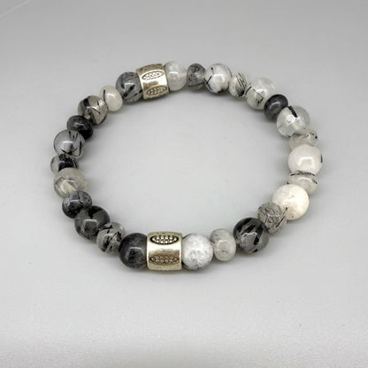 Rutilated quartz beaded bracelet, 18cm, black-white-grey gemstone beads with two decorated metal spacers on elastic band.