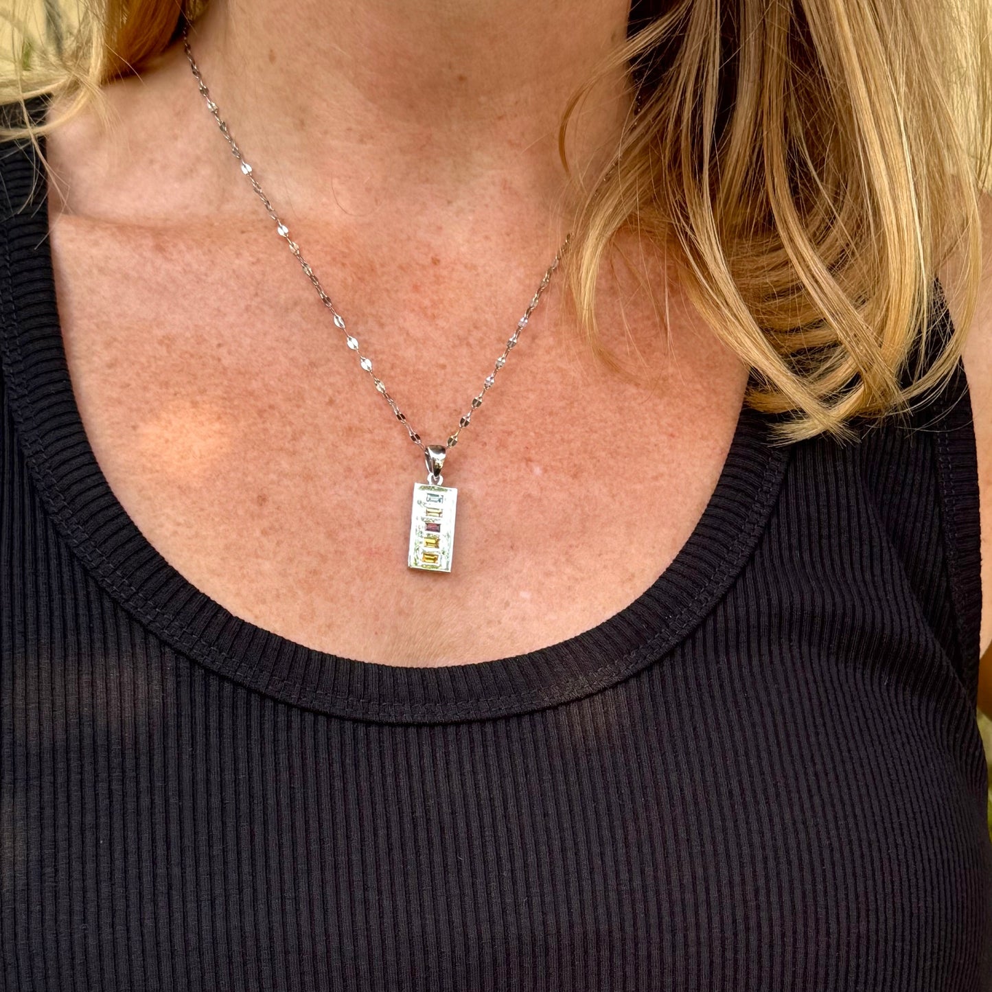 Handmade pendant featuring 0.8 ct fancy sapphires in yellow, pink, and blue, set in white-gold-plated sterling silver.