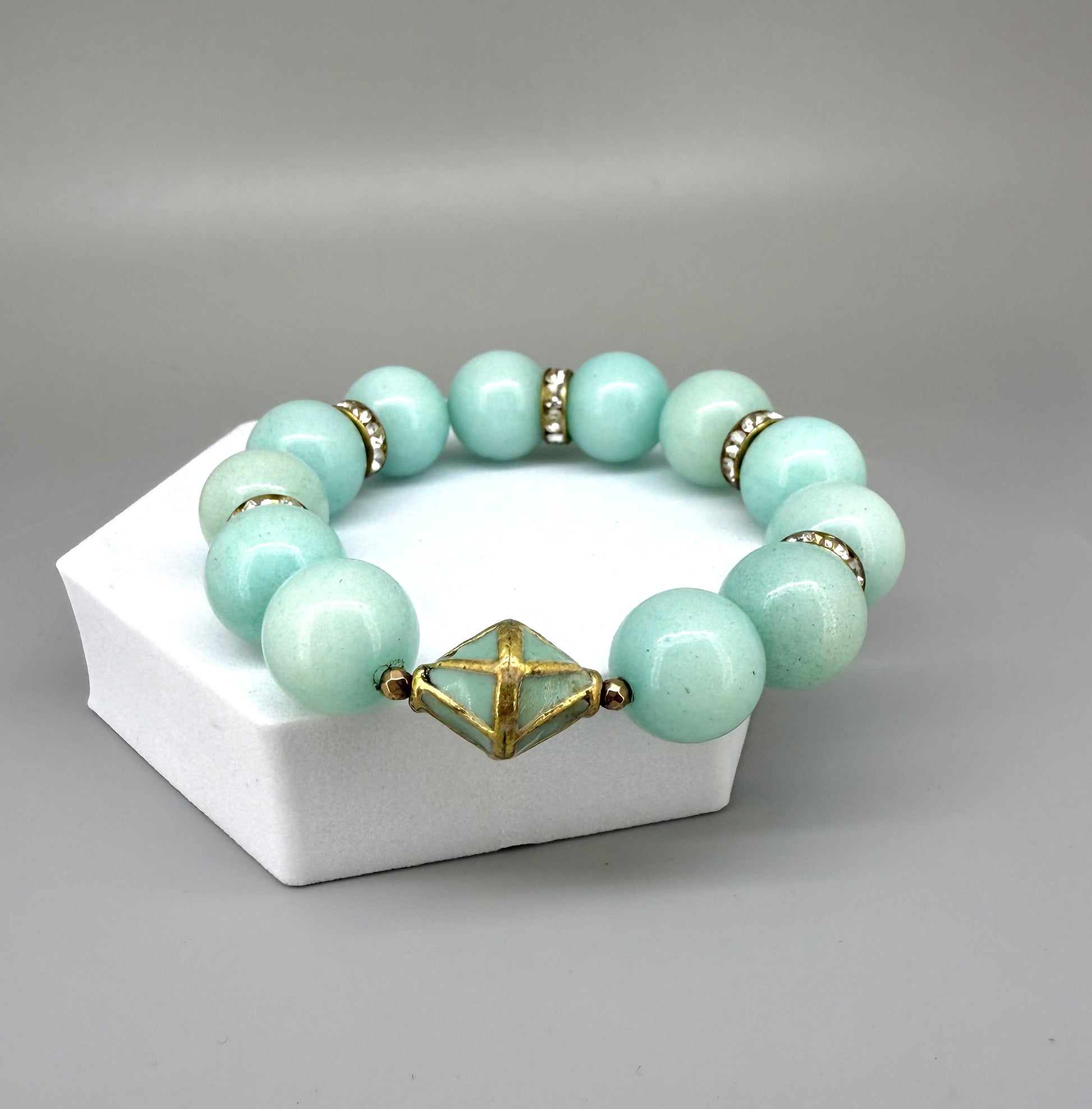 Larimar beaded bracelet, 18cm, aqua-blue gemstone beads with gold-toned spacers and decorative golden focal accent on elastic stretch band.