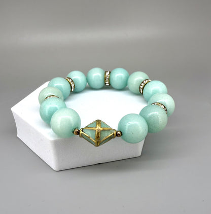 Larimar beaded bracelet, 18cm, aqua-blue gemstone beads with gold-toned spacers and decorative golden focal accent on elastic stretch band.