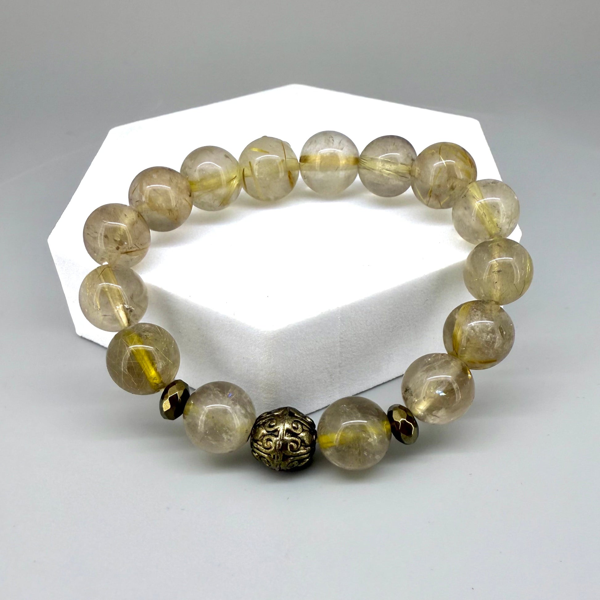 Rutilated quartz beaded bracelet, natural golden rutile gemstone beads with one carved metal accent bead on elastic stretch band.