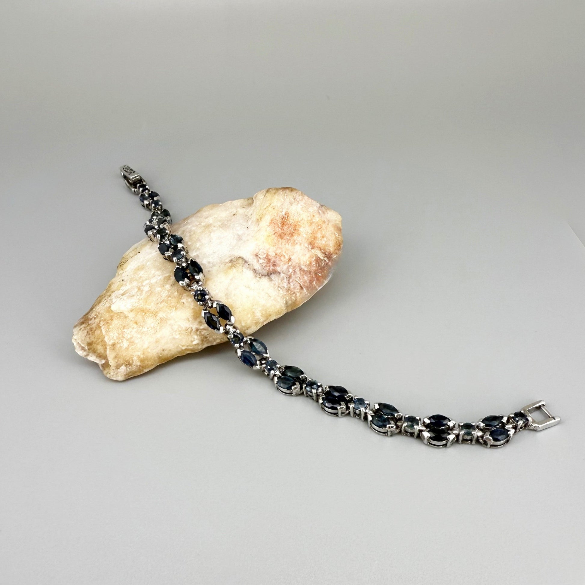 White gold plated sapphire bracelet in sterling silver on neutral background
