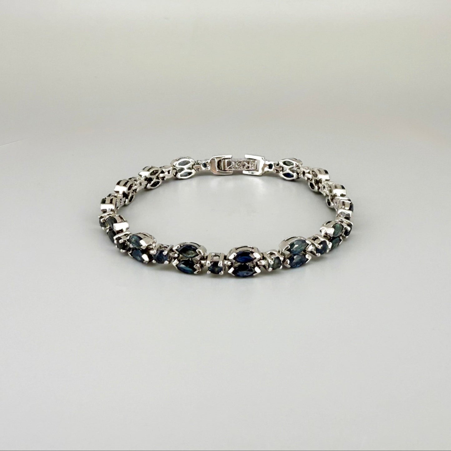 White gold plated sapphire bracelet in sterling silver on neutral background