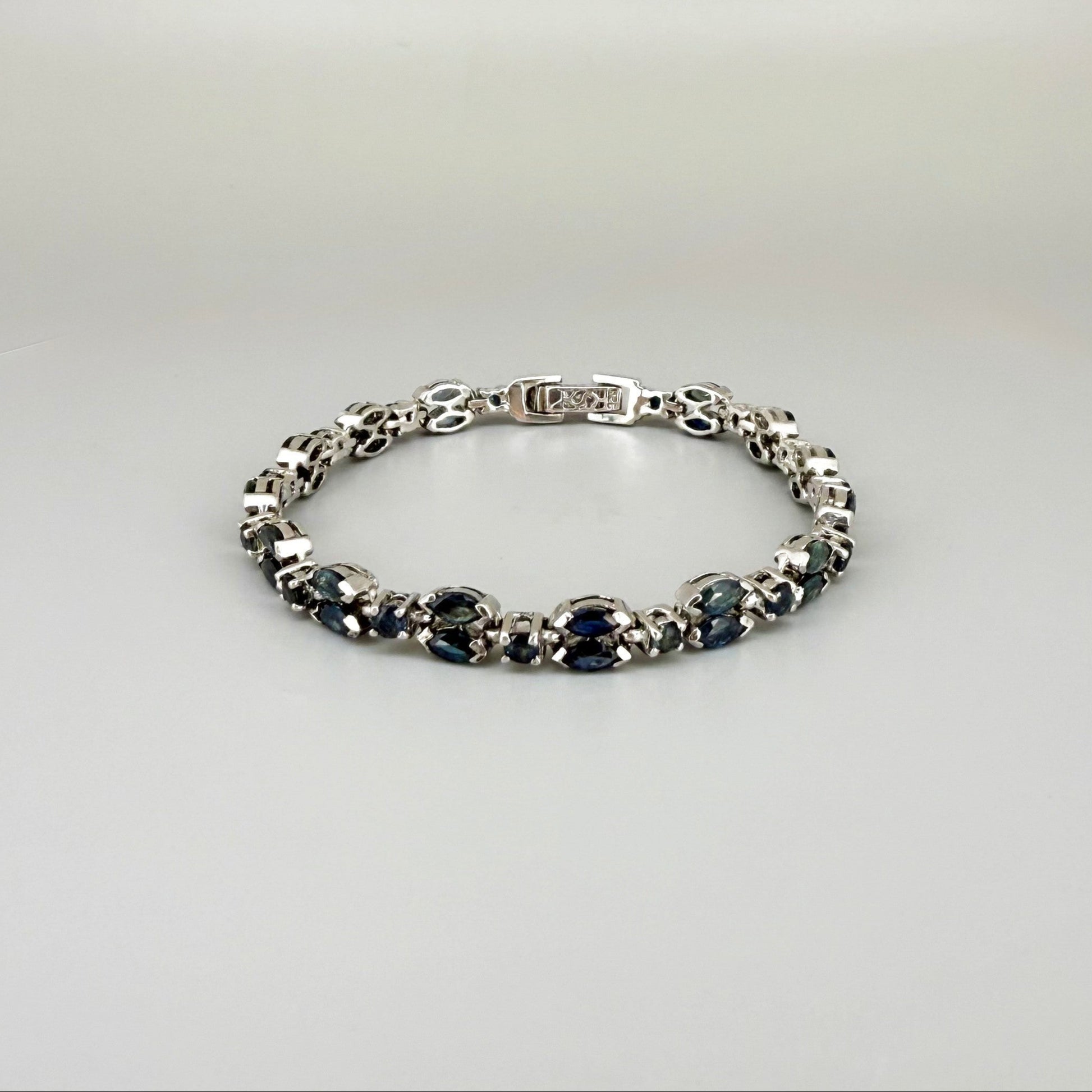 White gold plated sapphire bracelet in sterling silver on neutral background