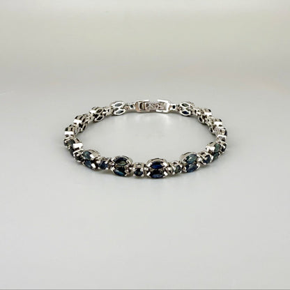 White gold plated sapphire bracelet in sterling silver on neutral background