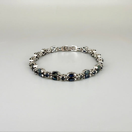 White gold plated sapphire bracelet in sterling silver on neutral background