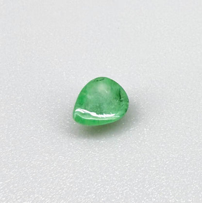 0.51 ct natural untreated emerald from Zambia, one side polished and the other cabochon-shaped.
