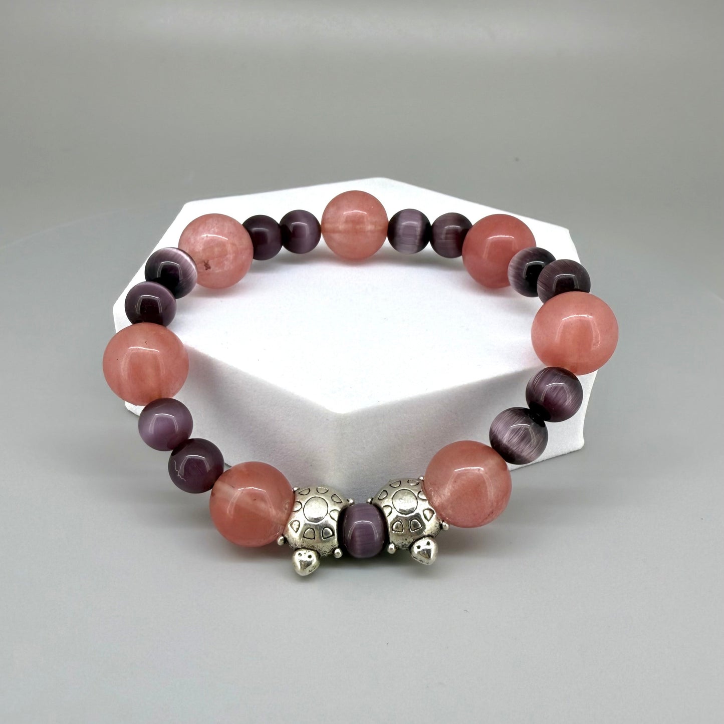 Cherry quartz and cat’s eye beaded bracelet, 18cm, pink and shimmering gemstone beads with two turtle accents on elastic stretch band.