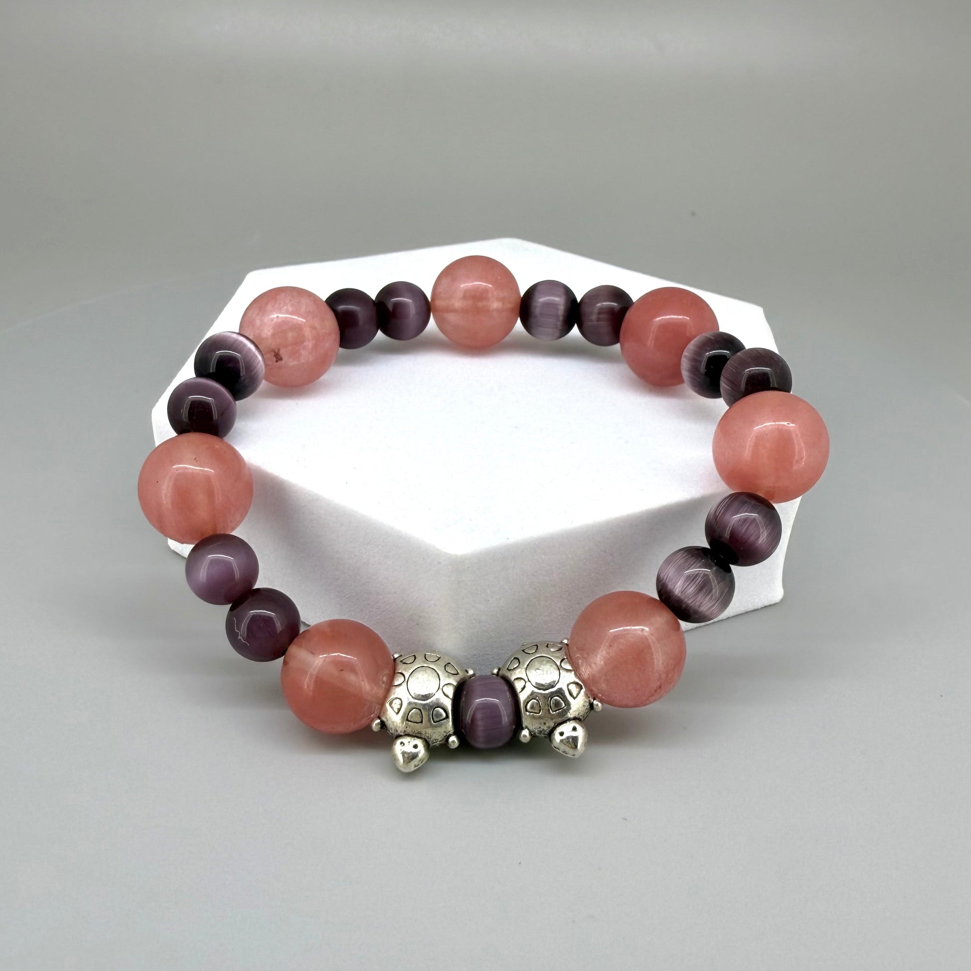 Cherry quartz and cat’s eye beaded bracelet, 18cm, pink and shimmering gemstone beads with two turtle accents on elastic stretch band.