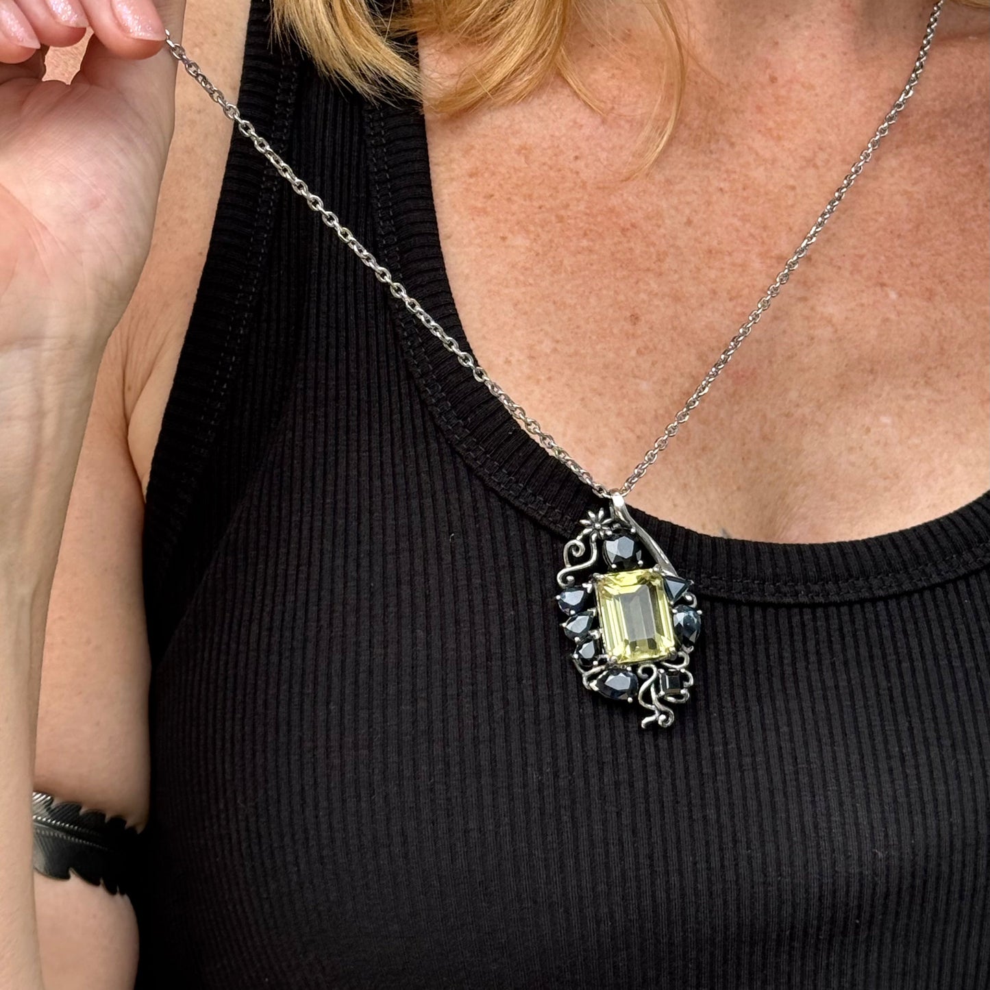 Handcrafted pendant with lemon quartz and blue sapphires set in white-gold-plated sterling silver.