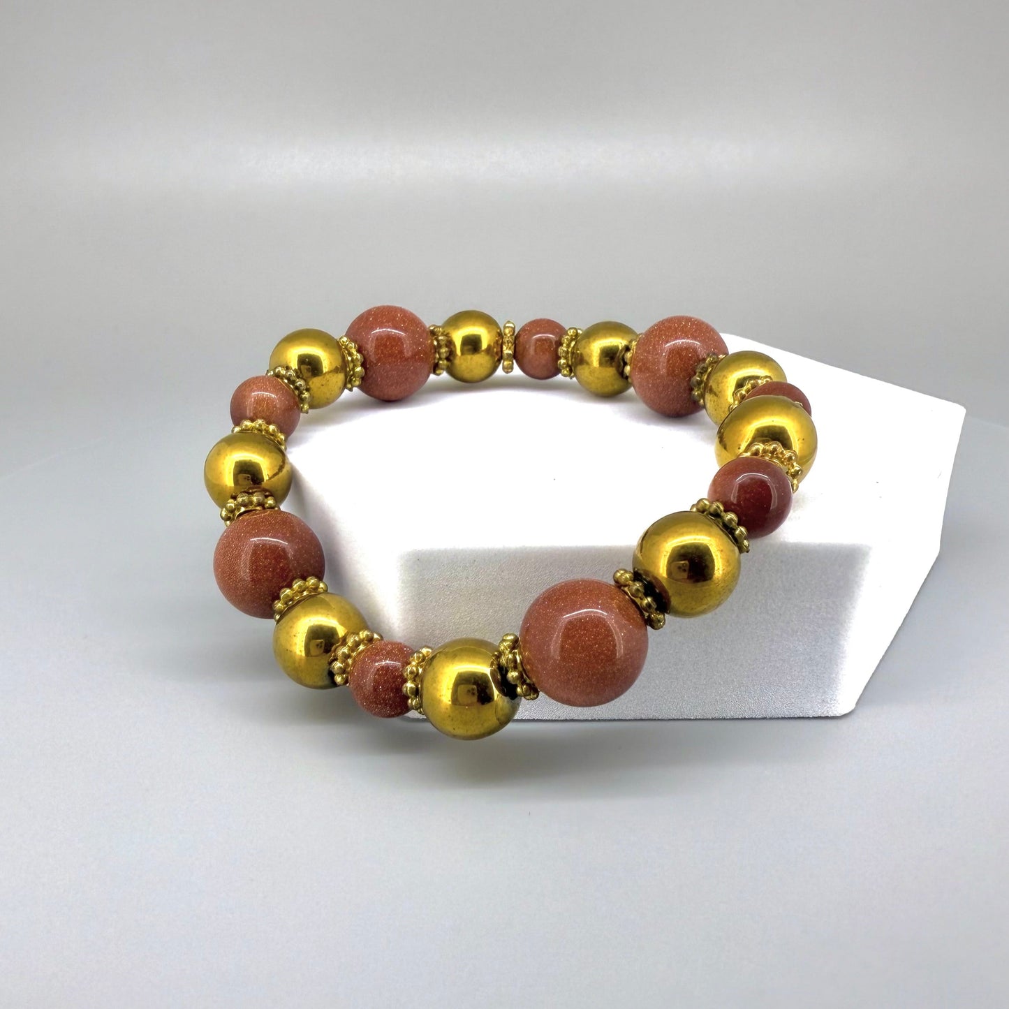 Hematite and goldstone beaded bracelet, 18cm, metallic gold and shimmering golden-copper beads on elastic stretch band.