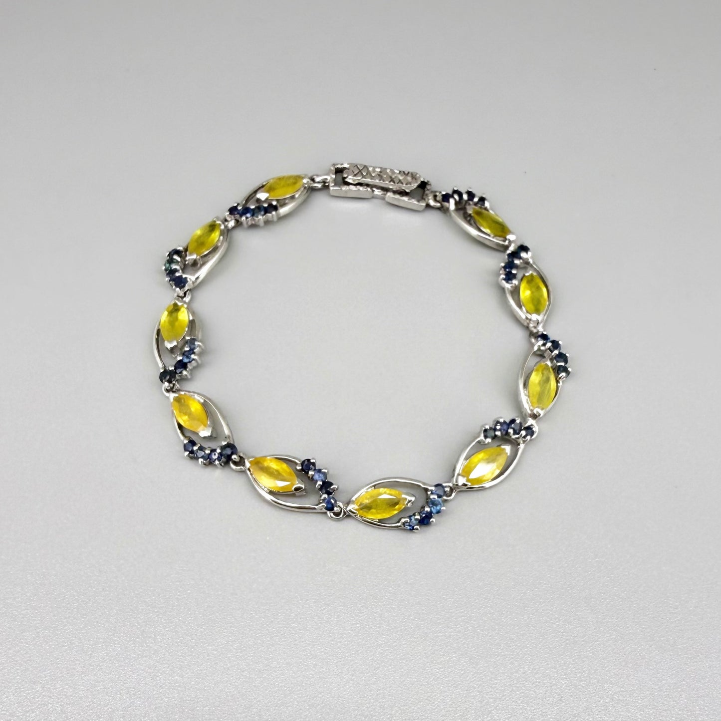 Sapphire bracelet with yellow and blue gemstones set in white gold plated silver