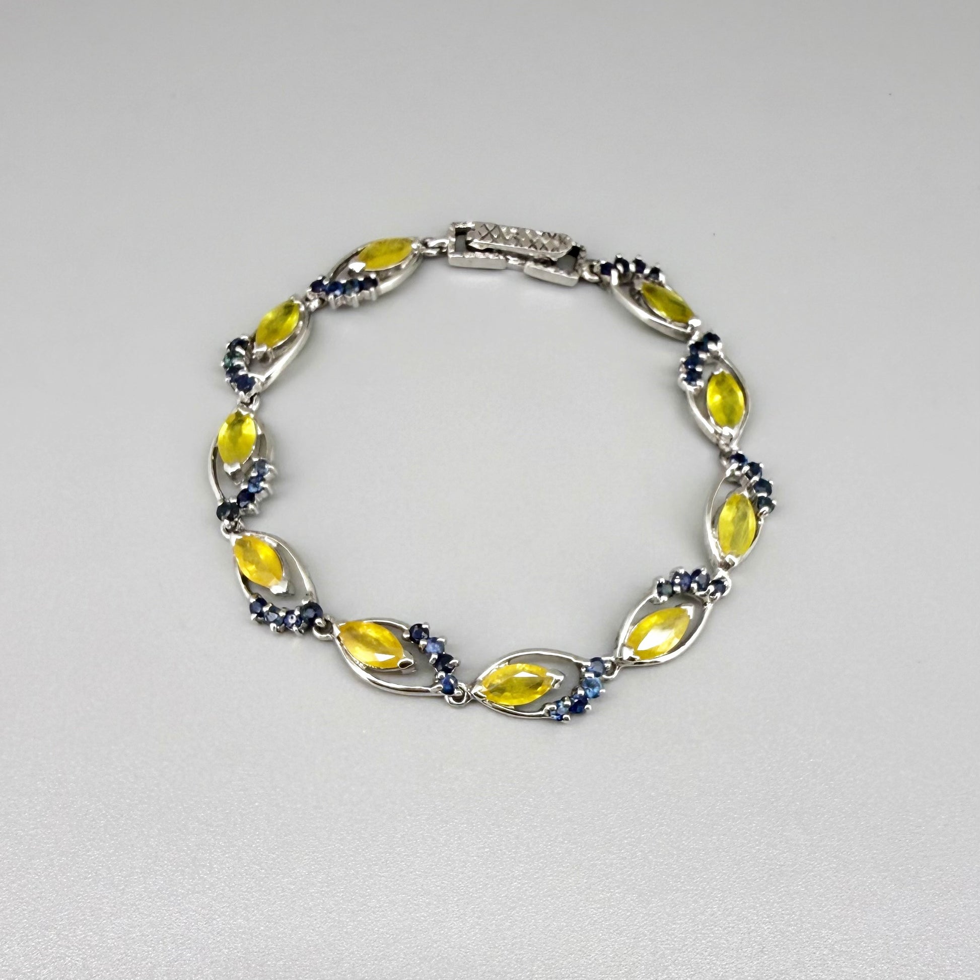 Sapphire bracelet with yellow and blue gemstones set in white gold plated silver