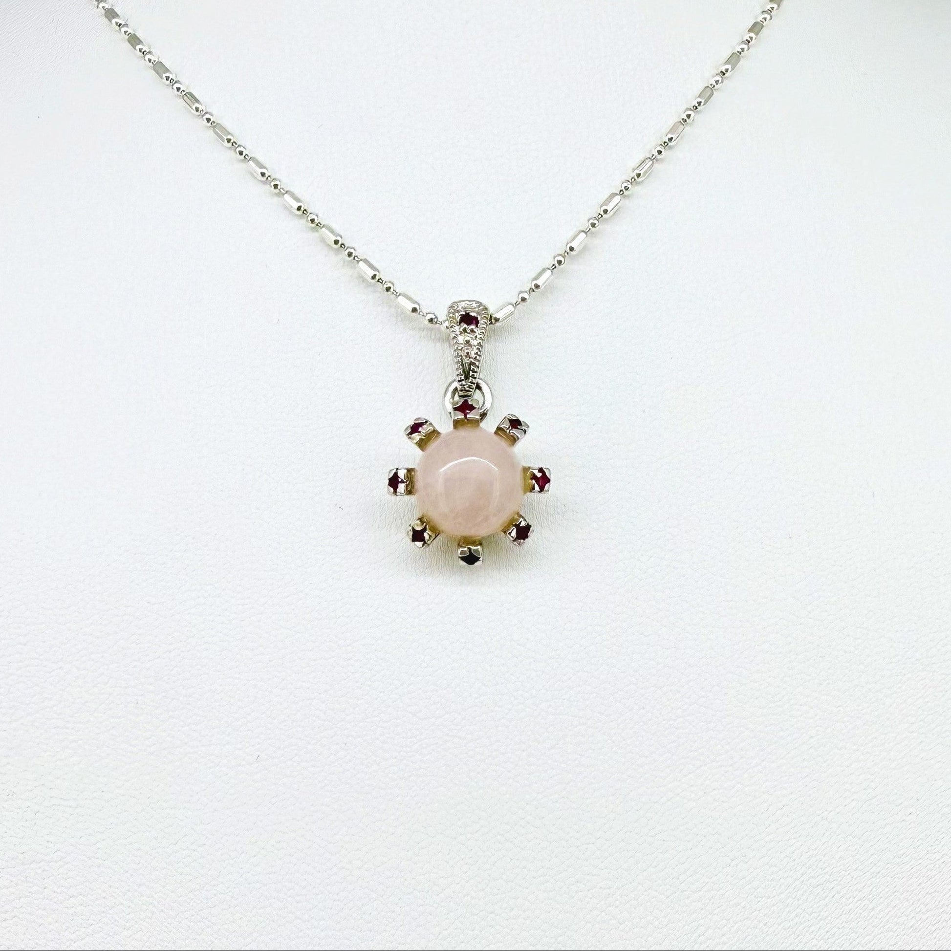 Handmade pendant with 4.02 ct rose quartz and 0.23 ct rubies, set in white-gold-plated sterling silver.