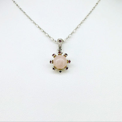 Handmade pendant with 4.02 ct rose quartz and 0.23 ct rubies, set in white-gold-plated sterling silver.