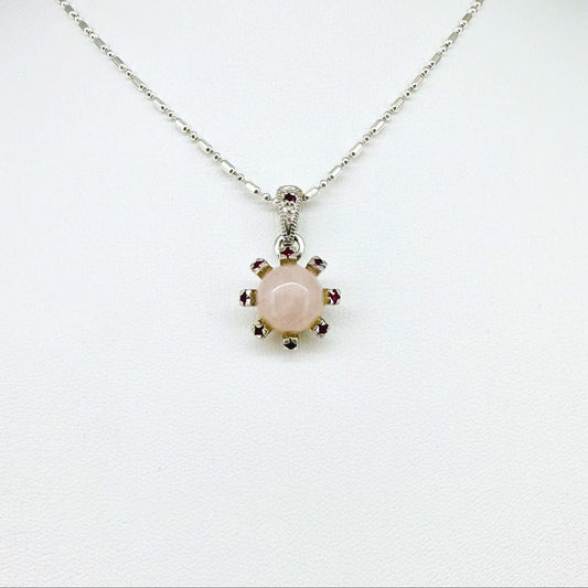 Handmade pendant with 4.02 ct rose quartz and 0.23 ct rubies, set in white-gold-plated sterling silver.