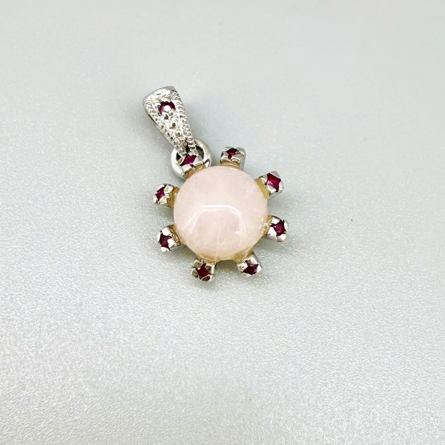 Handmade pendant with 4.02 ct rose quartz and 0.23 ct rubies, set in white-gold-plated sterling silver.