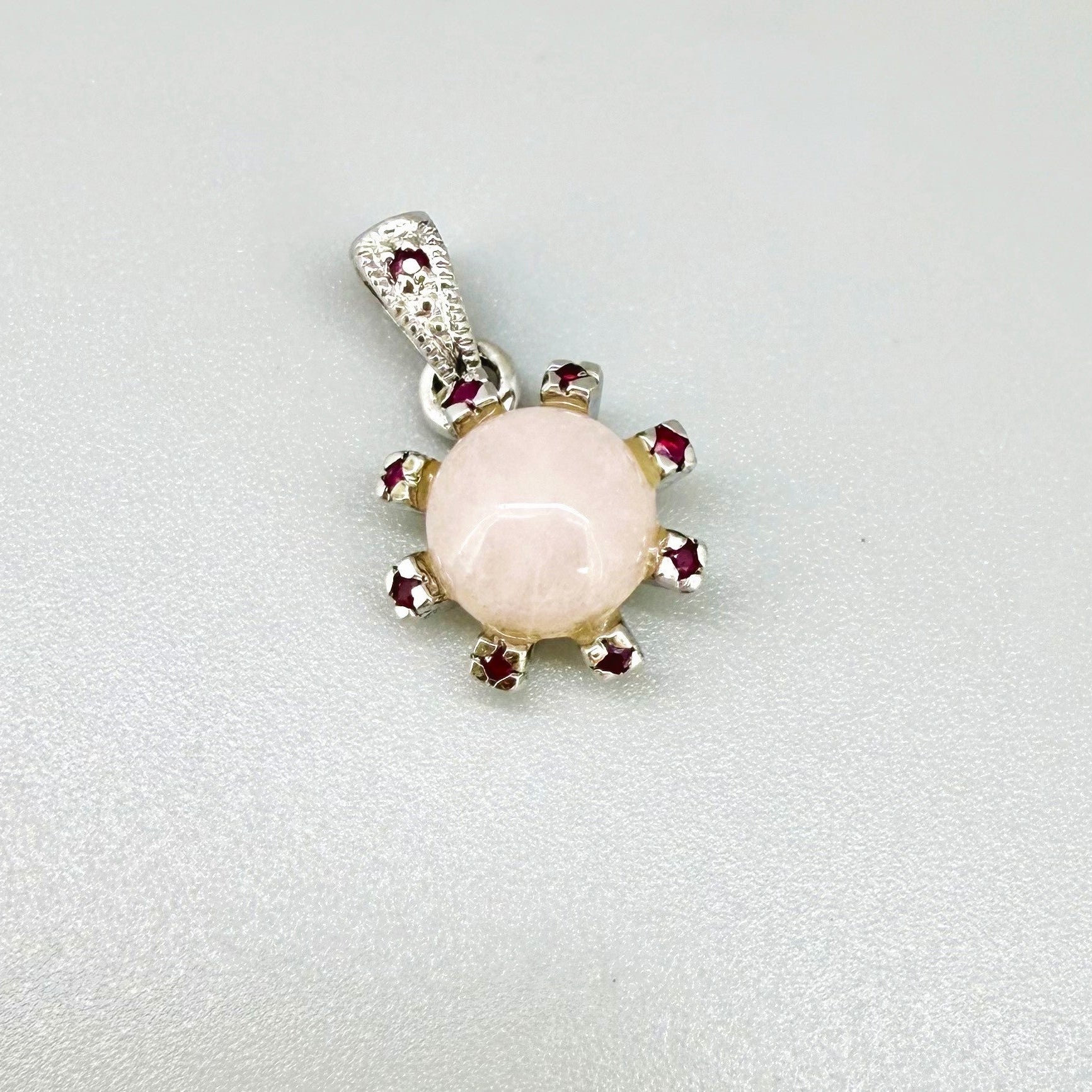 Handmade pendant with 4.02 ct rose quartz and 0.23 ct rubies, set in white-gold-plated sterling silver.