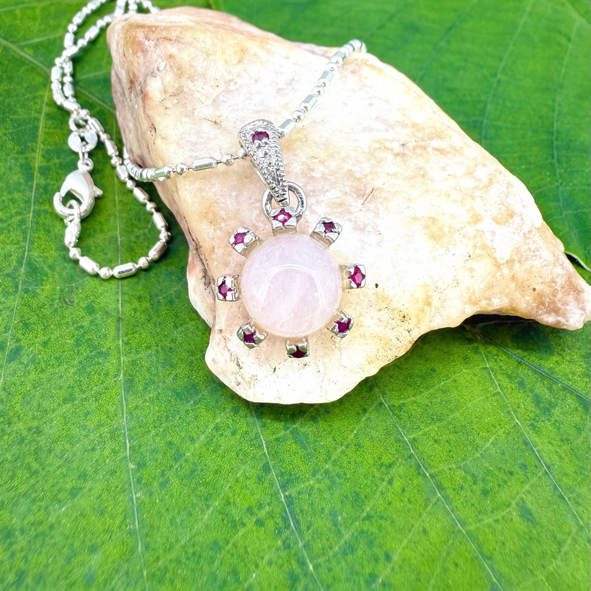 Handmade pendant with 4.02 ct rose quartz and 0.23 ct rubies, set in white-gold-plated sterling silver.